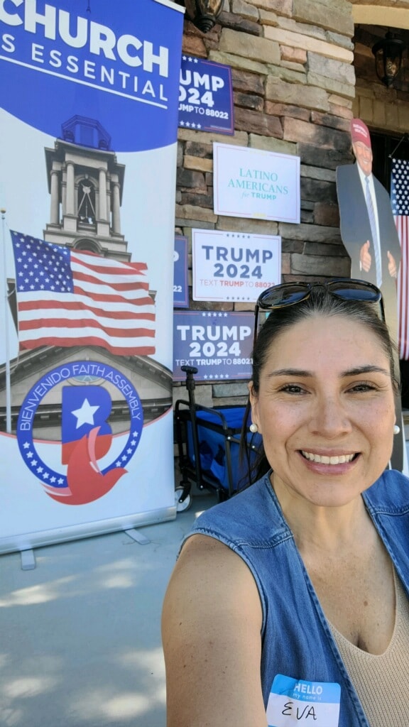 Woman at political event with Bienvenido banners