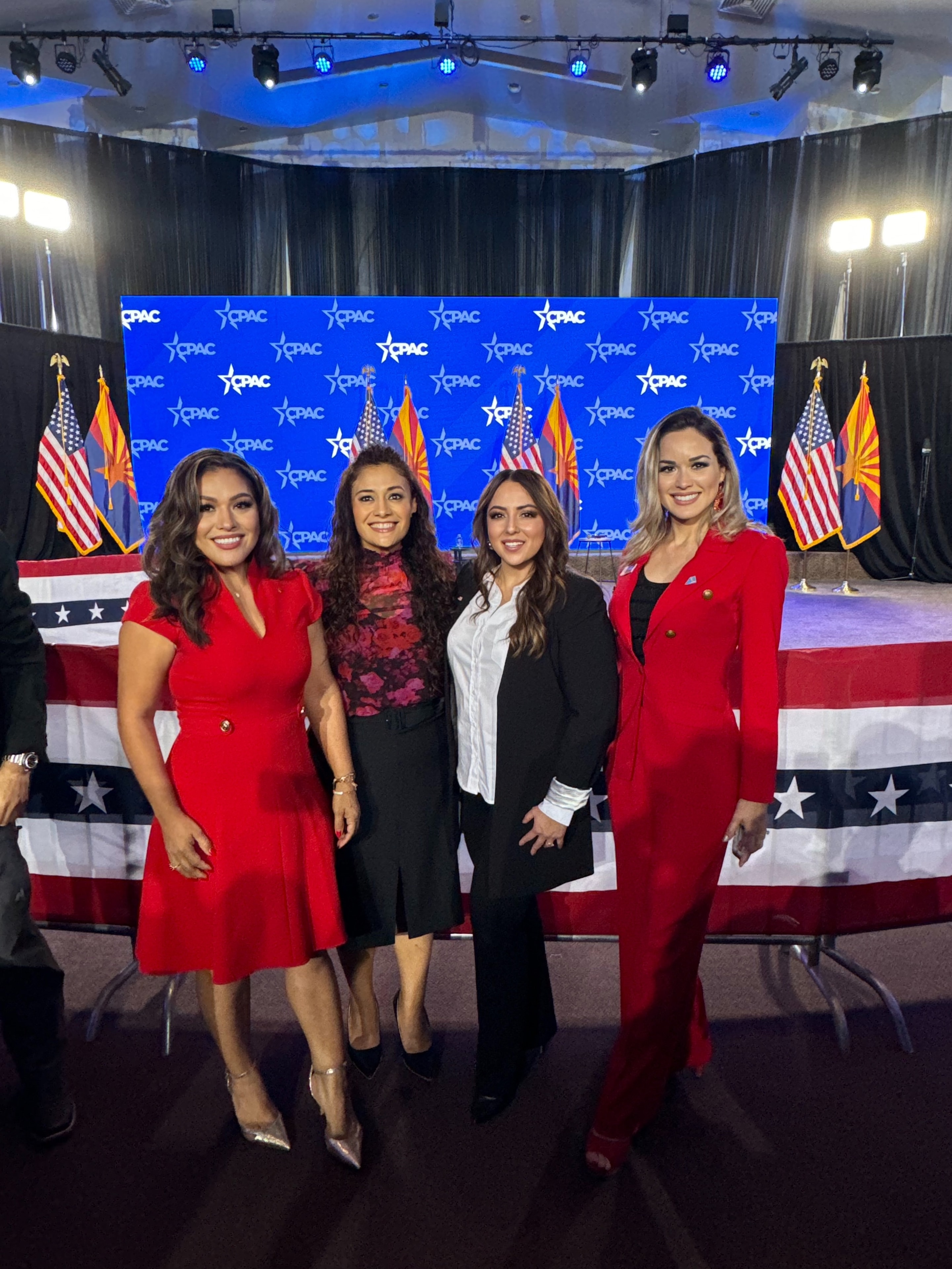 Four women at CPAC event with American flags