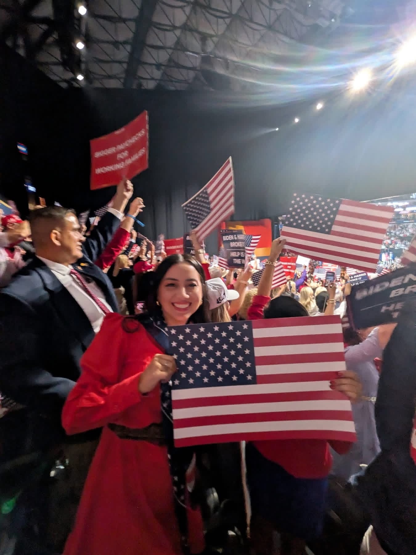 Woman holding American flag at political rally