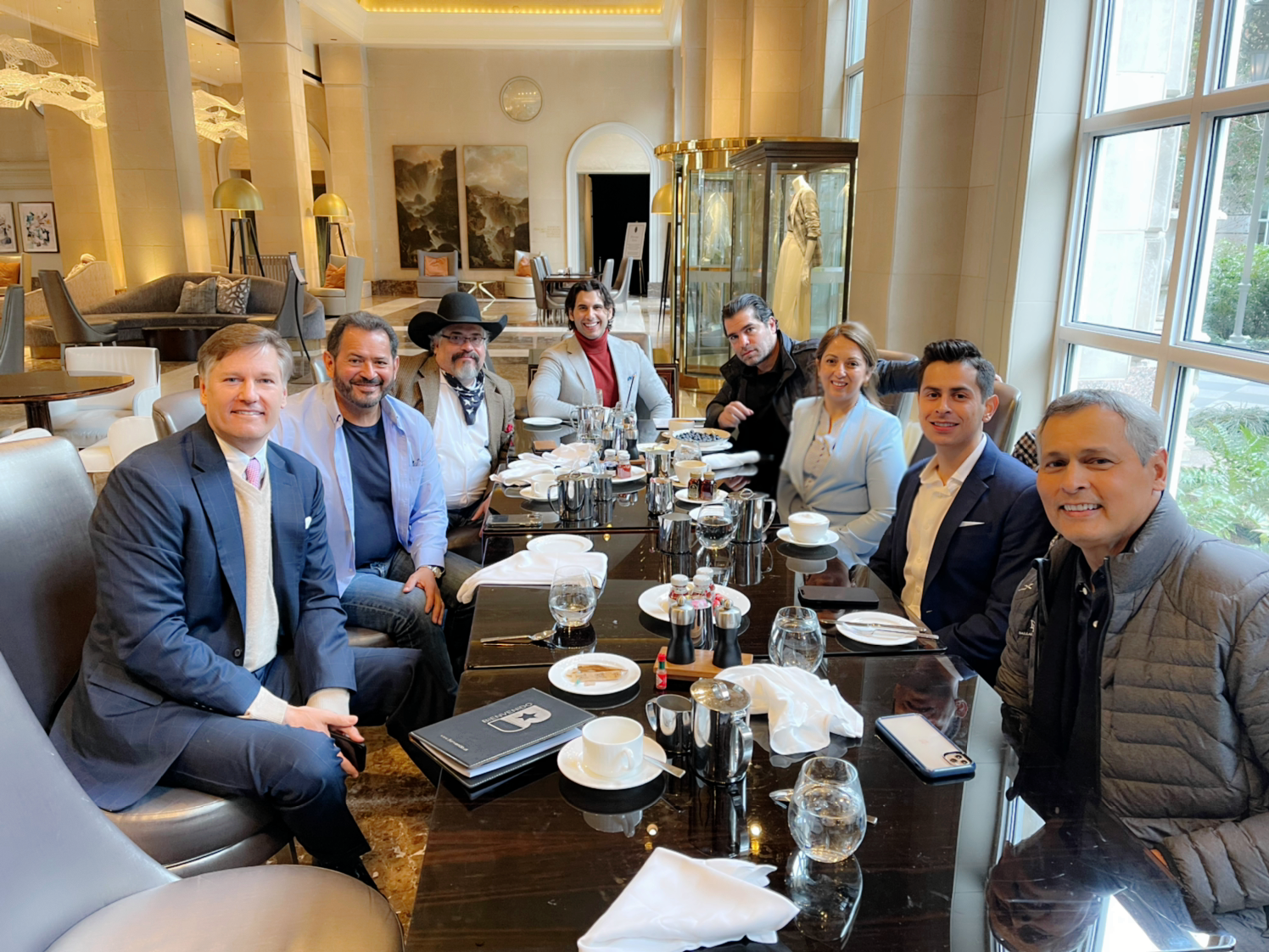Team group photo at upscale dining table